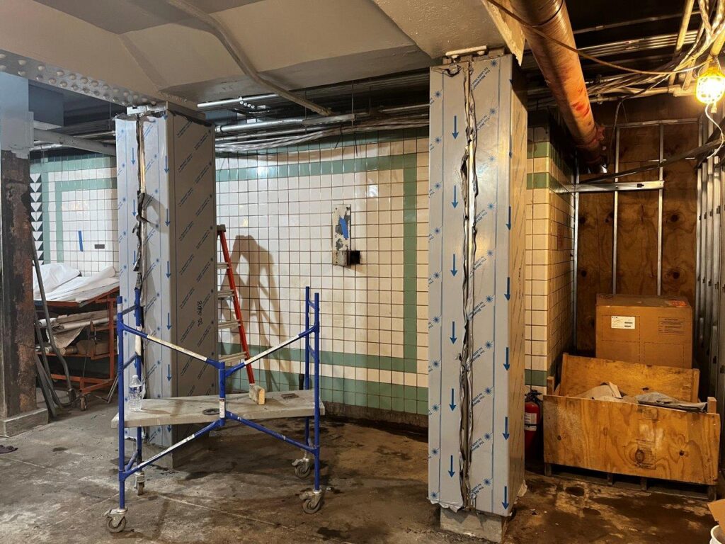 Decorative stainless steel column covers are now being installed in the Concourse.