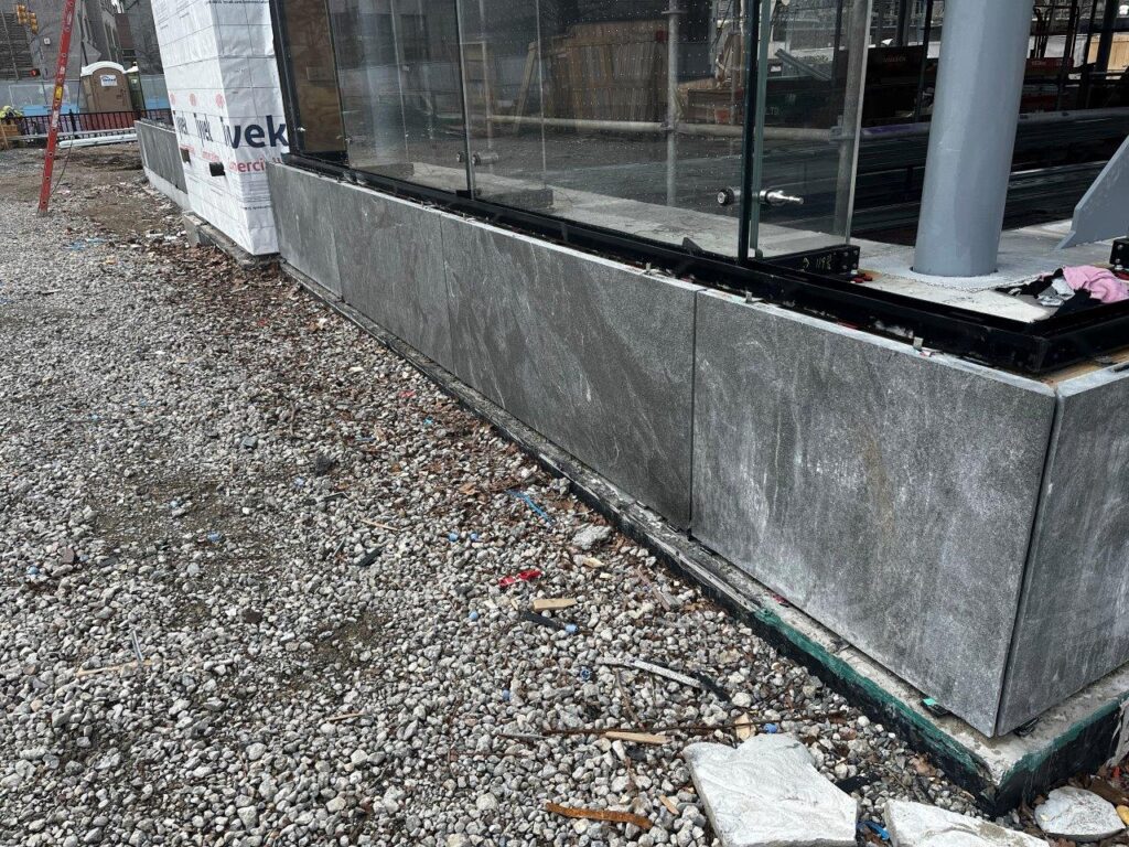 Entrance Headhouse curb granite cladding installation is ongoing.