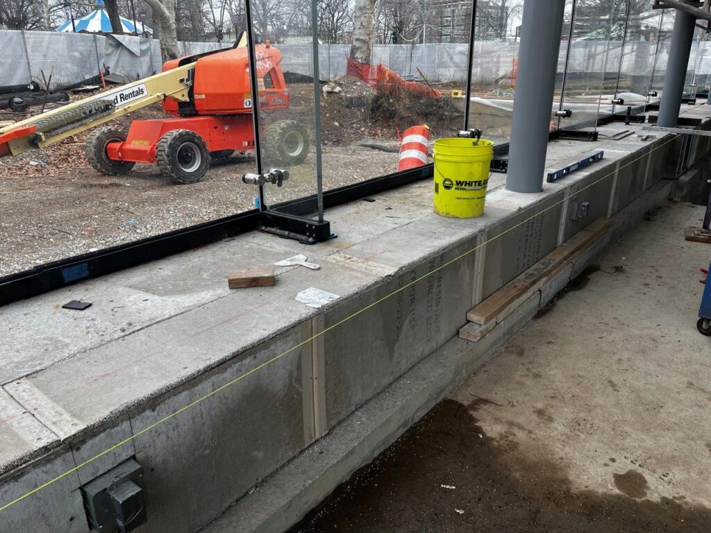 Cement board and cold-form framing installation along the Headhouse curbs is done in preparation for granite cladding installation.