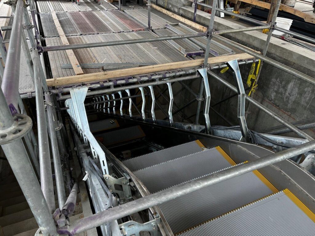 Installation of escalator components is ongoing.